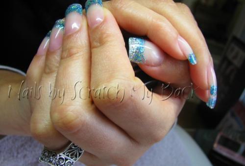 Gel nails with blue glitter sparkles on free edge